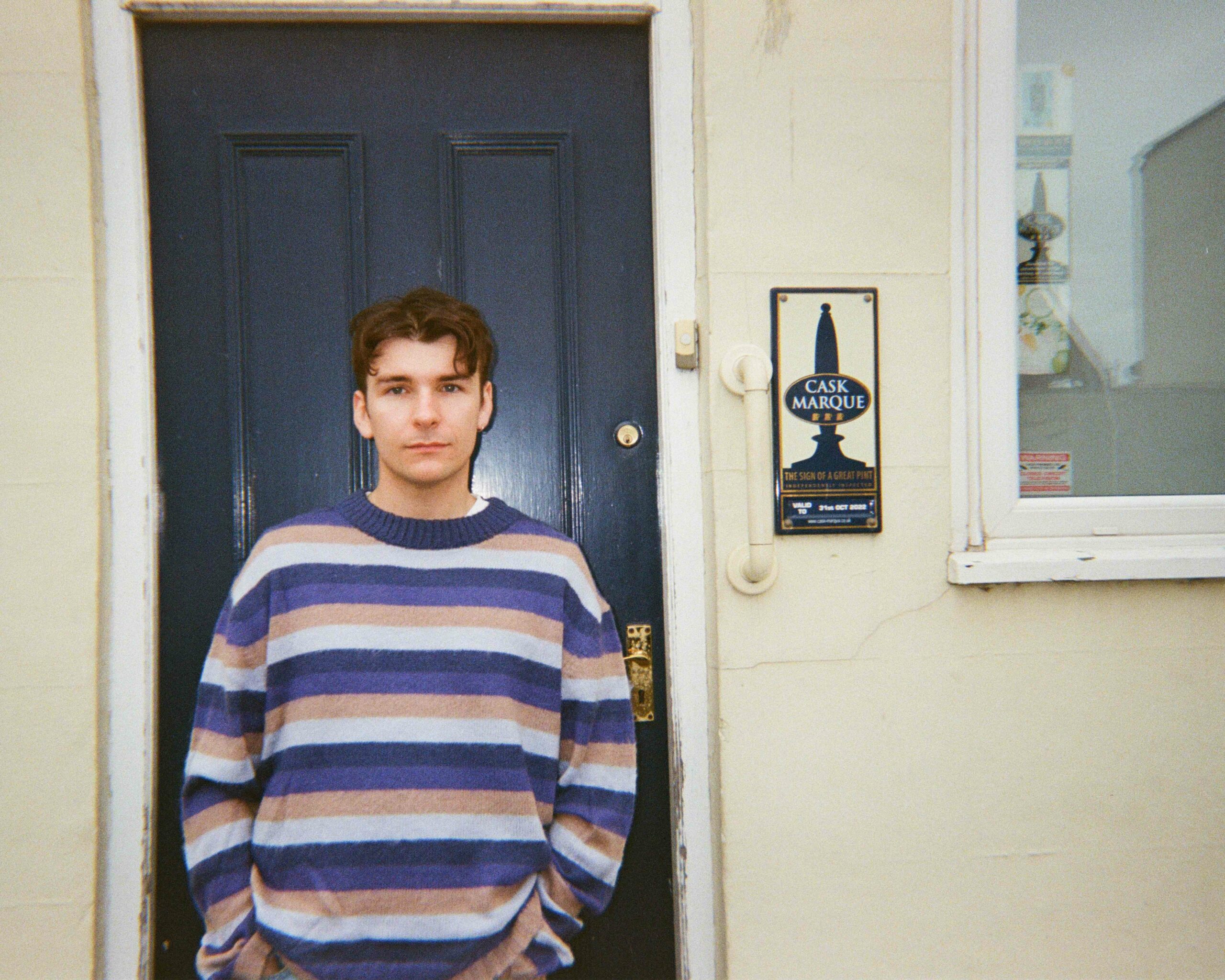 SAWKS stands in front of a front door and window