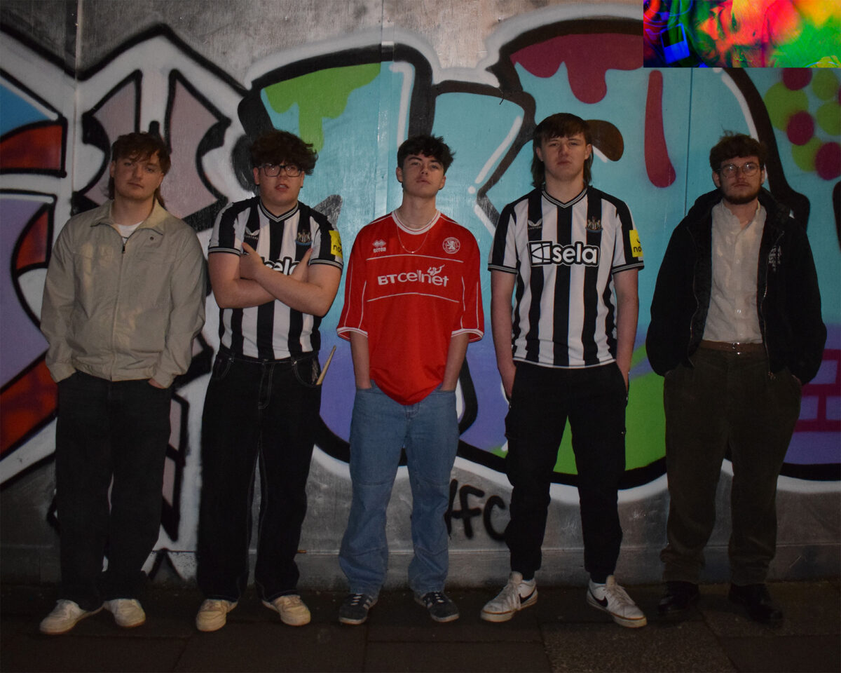 Five young men standing in a row against a colourful graffiti wall. Three of them are wearing football (soccer) shirts - two in black and white striped Newcastle United jerseys with "Sela" visible on one, and one in the middle wearing a red jersey with "BTCellnet" on it. The men on the far left and right are dressed differently - the leftmost in a light jacket, and the rightmost in a dark jacket with glasses.